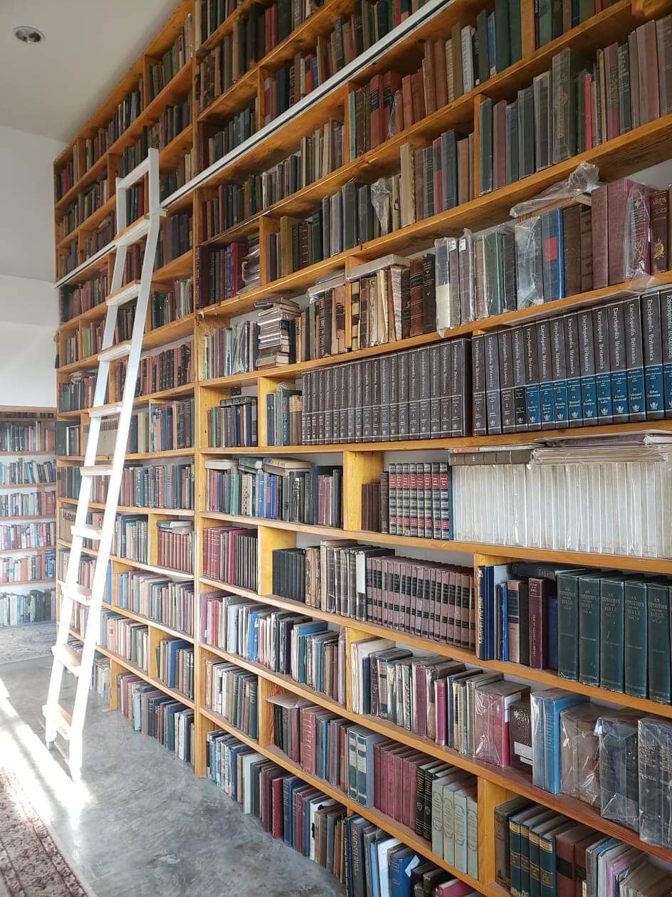 Floor-to-ceiling library bookshelves at Tree Roots Retreat, Rayong