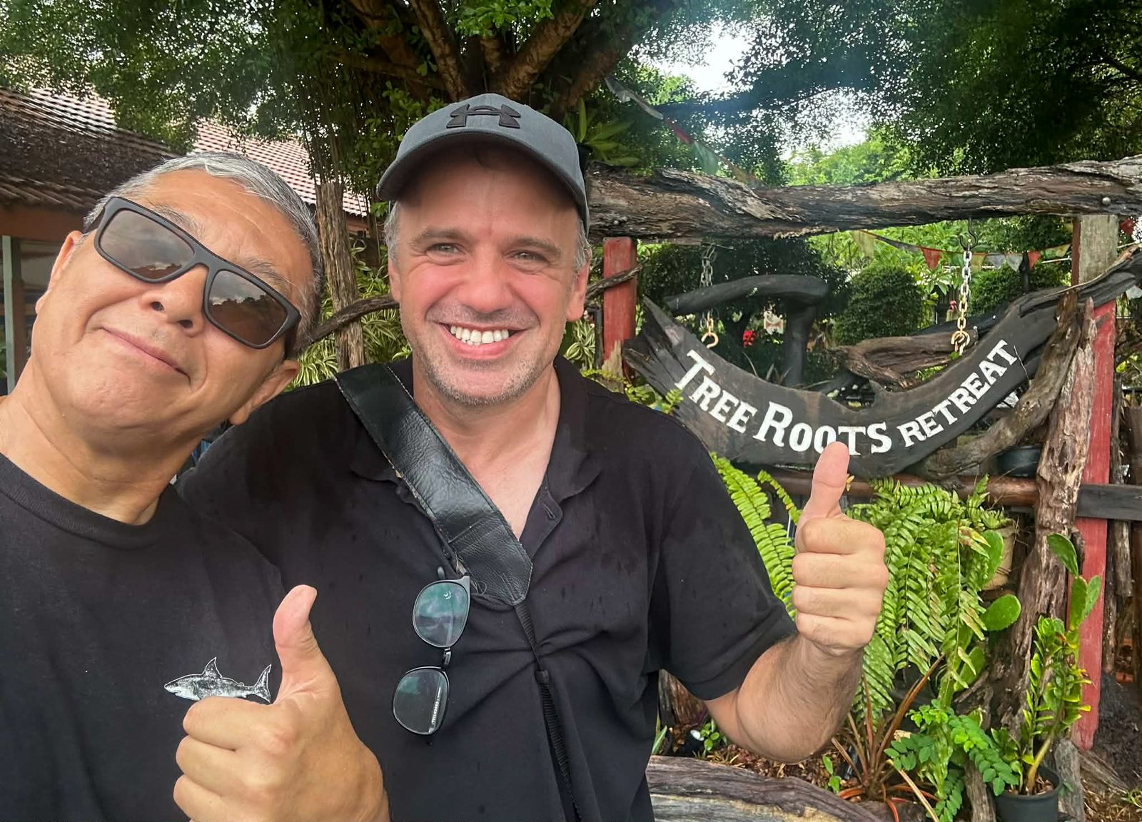 Michael and the host under the Tree Roots Retreat sign in Mae Ram Phueng, Rayong, Thailand &mdash; a farewell after a week of Brazilian Jiu-Jitsu training at the retreat.
