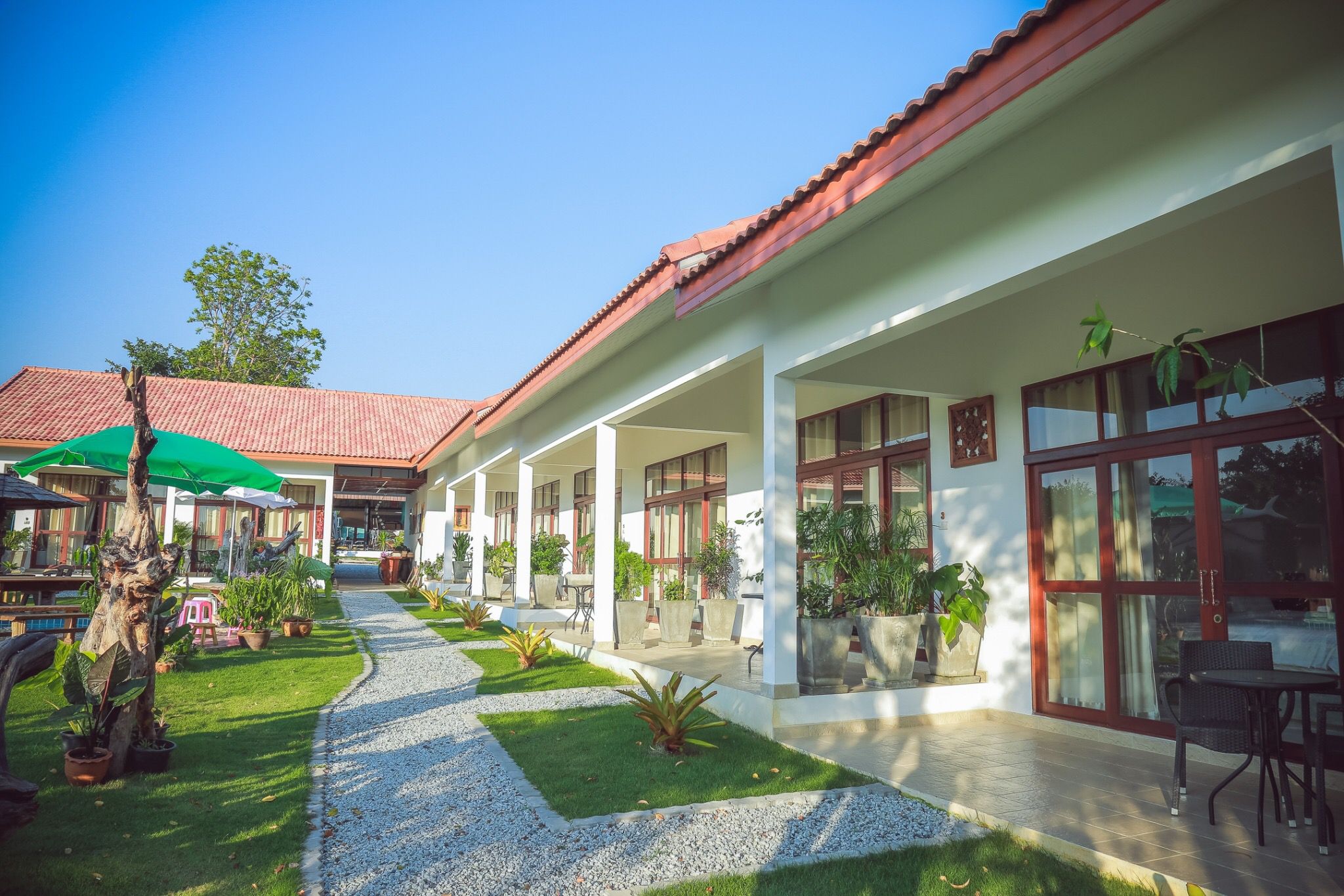 Garden walkway between rooms at Tree Roots Retreat, Rayong.